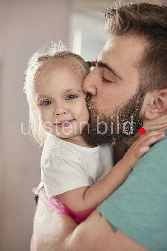 Father kissing his daughter
